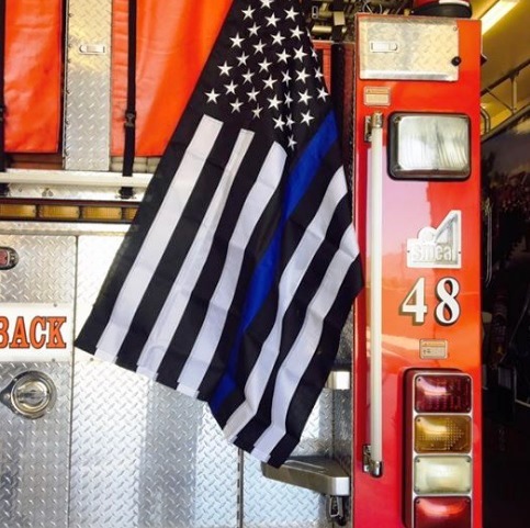 Firefighters ordered to remove flag from rig that honors fallen police ...